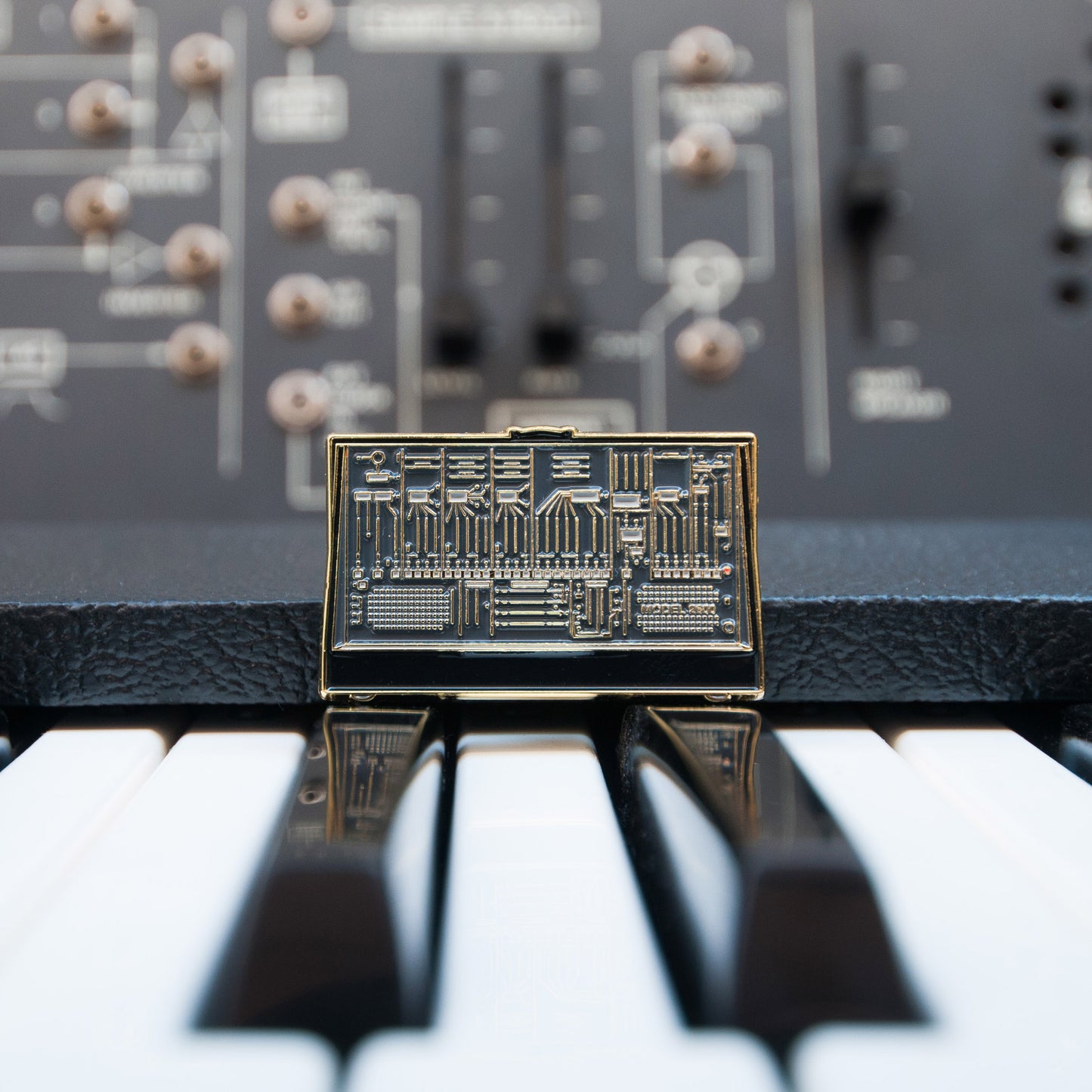 ARP Model 2600 Enamel Pin on top of ARP 2600